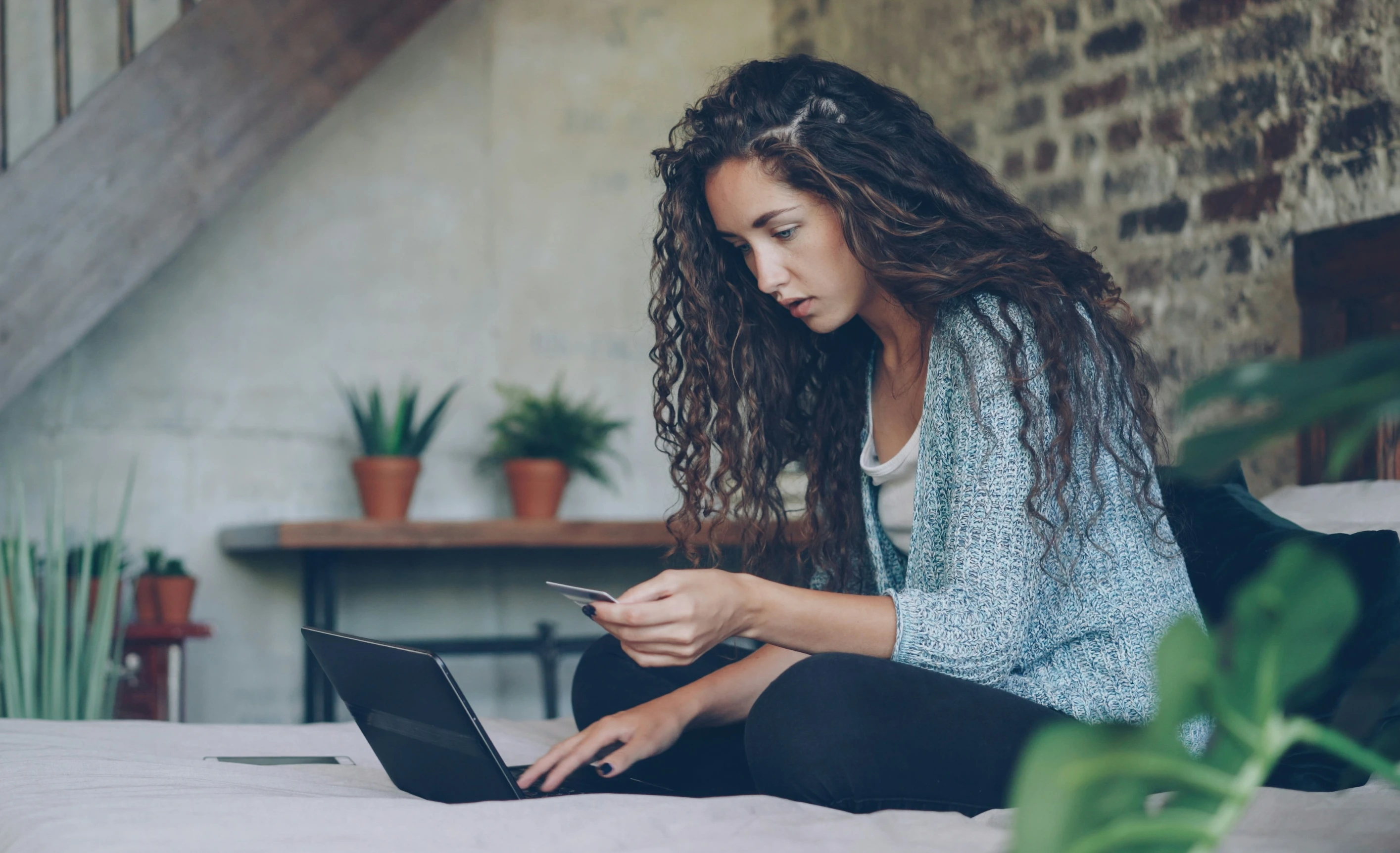 Woman paying with card online on laptop